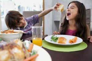 Brother feeding sister a roll
